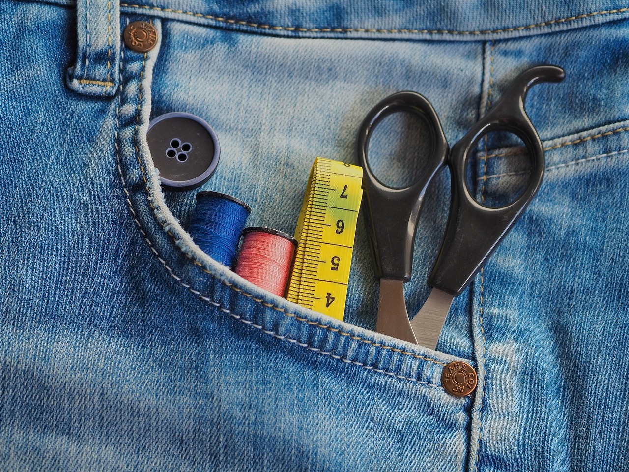 Stack of porcelain tile samples beside a tape measure